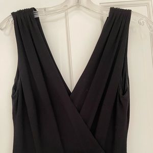 Knit black jumpsuit (crisscross top…fitted waist …stovepipe leg)